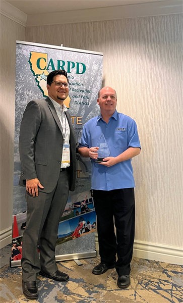 Matthew Duarte from CAPRI on left with CSDA CEO Neil McCormick from CSDA holding award.